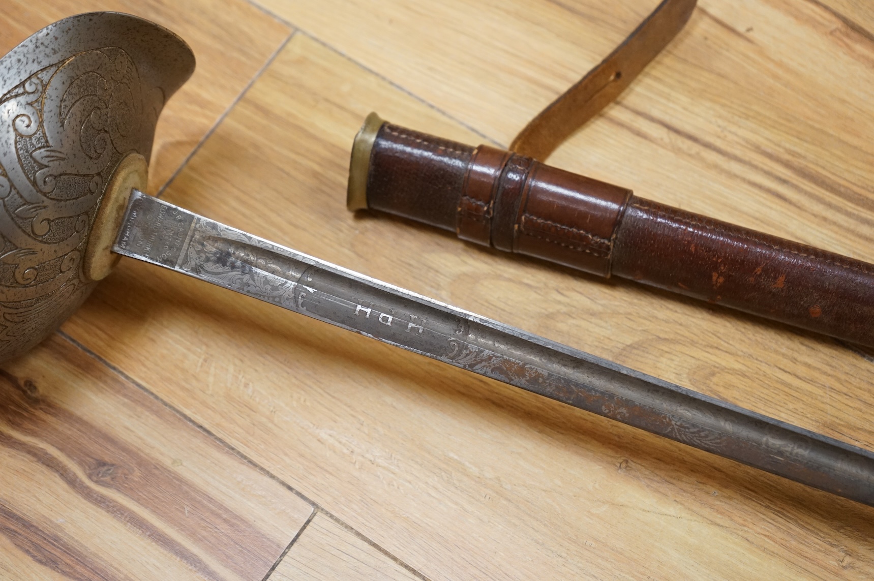 A 1911 pattern cavalry officer’s sword by J. Gaunt and son, etched with crowned GVR cipher and owner’s initials; HPH, regulation hilt and leather covered scabbard